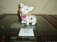 Front and side view of a ceramic piggy bank shaped like a pig decorated with Old Country Roses floral pattern and a floral wreath around its neck.