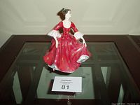Front view of Royal Doulton porcelain figurine 'Stephanie' featuring woman in red dress.