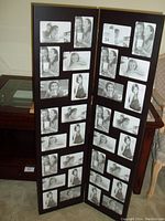 Photo showing a free standing two-panel folding picture frame with multiple photo openings in each panel, holding black and white sample photos.