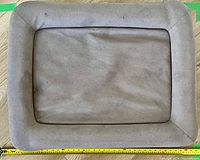 Top view of medium-sized Casper dog bed showing light brown fabric with some signs of wear and wear marks on surface.