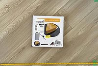 Photo of the product packaging showing the trap design shaped like a cheese wedge, instructions, and compatibility with a paint bucket for live capture of rodents.