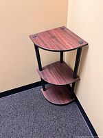 Corner table placed in corner against beige walls and carpeted floor.
