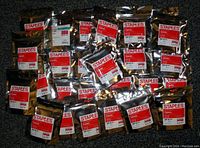 Lot of 26 sealed black replacement cartridges for Canon PIXMA iP100 printers with Staples packaging.