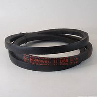 Coiled black V-belt with red printed text 'Hi-Power II B65'.