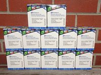 Lot of 12 boxed Dataproducts replacement inkjet cartridges, model CLI-271C, cyan color, arranged and stacked against wall.