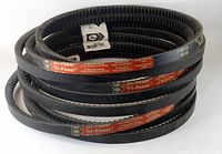 Three black Gates Tri-Power BX103 V-belts coiled and stacked showing full belt length and labels.