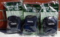 Three Roots 1973 small digital camera pouches in original packaging, dark blue and black fabric, visible embroidered ROOTS logos
