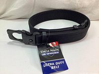 Front view of new Uncle Mike's Ultra Duty Belt with attached product tag, showing the hook and loop buckle and padded nylon material.
