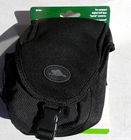 Front view of black Roots RP204 digital camera bag showing flap with buckle and overall nylon texture