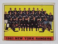 Front of the 1961-62 Topps New York Rangers team hockey card showing team photo with yellow background and team name at bottom.