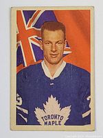 Front side of the 1963-64 Parkhurst hockey card featuring Eddie Shack in Toronto Maple Leafs uniform with orange and blue background and partial Union Jack flag.