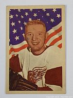 Front side of the 1963-64 Parkhurst Ian Cushnan hockey card showing player portrait with American flag background and Detroit Red Wings jersey.