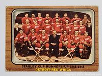 Front of the 1966-67 Topps Detroit Red Wings team card showing the team photo with players and staff in red uniforms and the labeling of the Stanley Cup runner-up year.