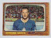 Front side of hockey card showing Edward Shack in a Toronto Maple Leafs jersey with stadium background and name text.