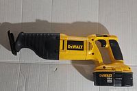 Full side view of yellow and black DeWALT cordless reciprocating saw showing model DW938 and attached 18V XRP battery.