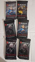Seven Magic The Gathering Core Set 2020 booster packs with various character art on front, arranged on white background.
