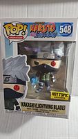Front view of Naruto Kakashi Funko Pop figure in box showing character, number 548, and Hot Topic exclusive sticker.