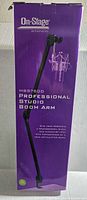 Box front and side views showing the On-Stage brand and model MBS7500 with Professional Studio Boom Arm text and product image of articulating boom arm attached to a desk.