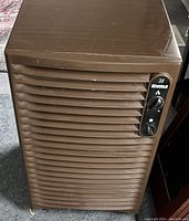 Front view of brown Kenmore dehumidifier showing horizontal vents and control knobs