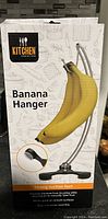 Photo of the boxed Kitchen Creations Banana Hanger showing product image and features