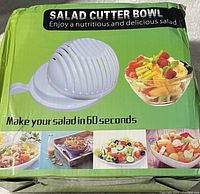 Photo of the salad cutter bowl packaging showing the product and promotional images of salads made using it.