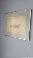 Framed artwork showing running wolf against wall