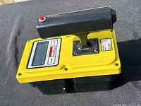 Side perspective showing overall device shape, handle and housing condition