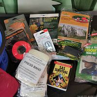 Overview of lot showing all items including survival tape, press bandage, SAS survival guide, and emergency shelter materials.