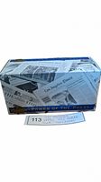 Photo of the sealed box showing newspaper collage design and 'Power of the Press' slogan.
