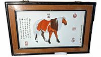 Front view of entire framed porcelain plaque showing horse illustration, calligraphy and frame
