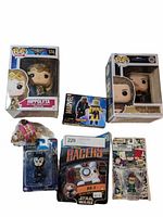 Photo showing 2 Funko Pop figures in boxes, Marvel Minimates toy, Star Wars BB-8 racer, Green Lantern keychain, and small novelty figurine.