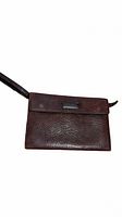 Front view of mahogany colored leather clutch with flap and brand plaque