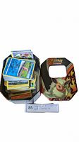 Another view of the large stack of Pokemon reverse holo cards inside the Flareon tin showing various cards, highlighting the quantity and variety.