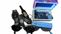 Photo of the watches, sunglasses, keychain beer bottle, and jewelry box with blue interior showing contents inside.