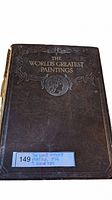 Front cover view of the antique book showing embossed design and gold lettering 'The World's Greatest Paintings'. Sticker with lot info on lower edge.