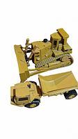 Side view of two vintage yellow diecast construction toys, a CAT bulldozer and a dump truck, showing details and condition.