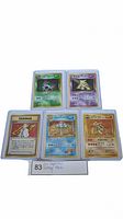 Front view showing five vintage Japanese holographic Pokemon cards in protective sleeves, titles visible.