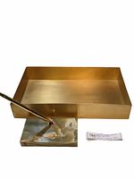Photo showing the solid brass letter tray and the marble pen holder with attached pen