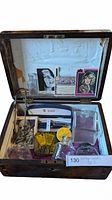 Open wooden inlaid box showing interior contents including horror movie trading cards, ink bottles, Billblass pen and pencil set, and paper items.