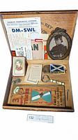 Wooden Primo Del Rey box containing framed vintage military photo, antique telegrams and listening cards, Authors card game, Scotland flag patch, whistle, small portrait card, and a sand timer.