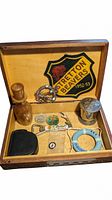 Full lot displayed in a carved wooden box with various Boy Scouts memorabilia including patches, badges, a wooden bottle, wooden gadgets, and a metal container