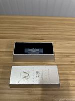 Roll of Wyoming State Quarters in a blue wrap inside a silver presentation box.