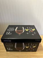 Box showing front with image of wine glasses and details about the 12-piece all-purpose wine stems set.