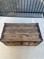 Top view of vintage wooden steamer trunk with metal bands and corner protectors
