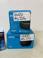 Photo of two Amazon Echo Dot boxes with 'USED AS-IS' stickers