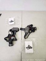 Two Boruit headlamps placed on a flat surface with accompanying documentation and protective packaging, showing front and side views.