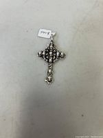 Front view of Italy sterling silver skull cross pendant showing detailed skull motifs and pendant loop, confirms new condition and 925 stamp.
