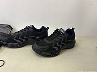 Pair of black Autper Air athletic shoes placed side by side showing outer sides and air cushioning soles.