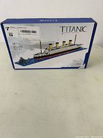 Box showing the brand BiduToy and the Titanic building blocks set with 1872 pieces recommended for ages 14+. Box art illustrates the finished ship model.