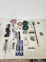 Full overhead view of the lot showing drill bits, pipe taps, cutting discs, tool organizers, and various accessories.